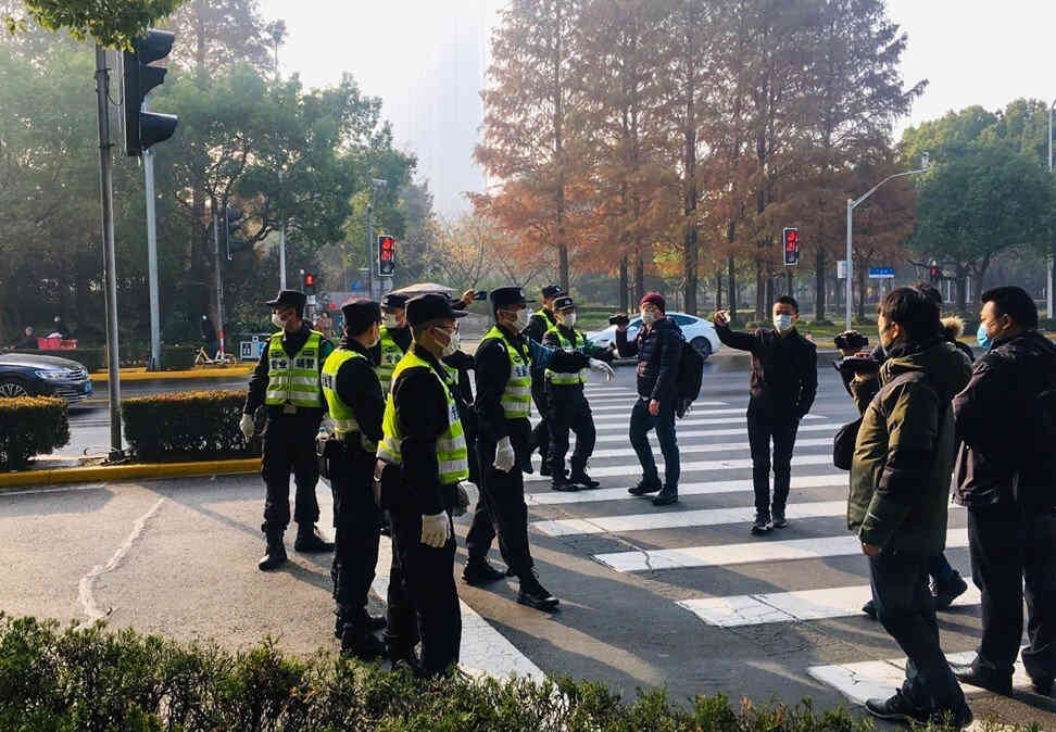 Polisi bergerak untuk mengusir jurnalis, warga, dan aktivis yang meminta memasuki ruang persidangan Zhang Zhan. @scmp.com